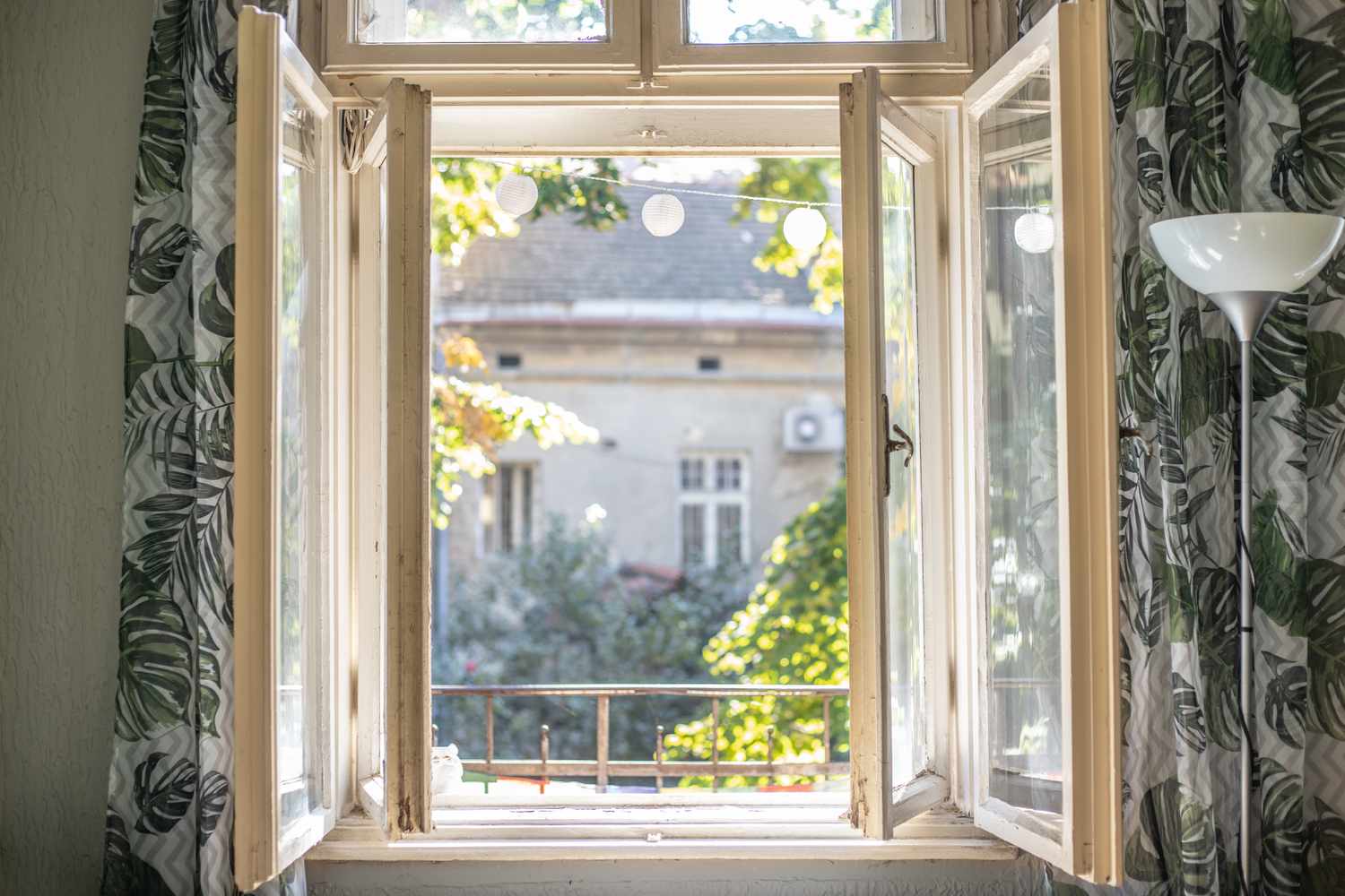 open window with curtains to garden