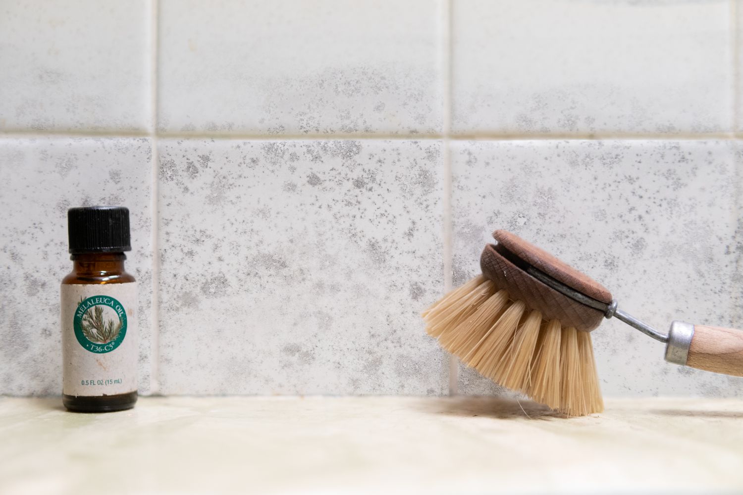 tea tree oil with wooden scrubber in shower